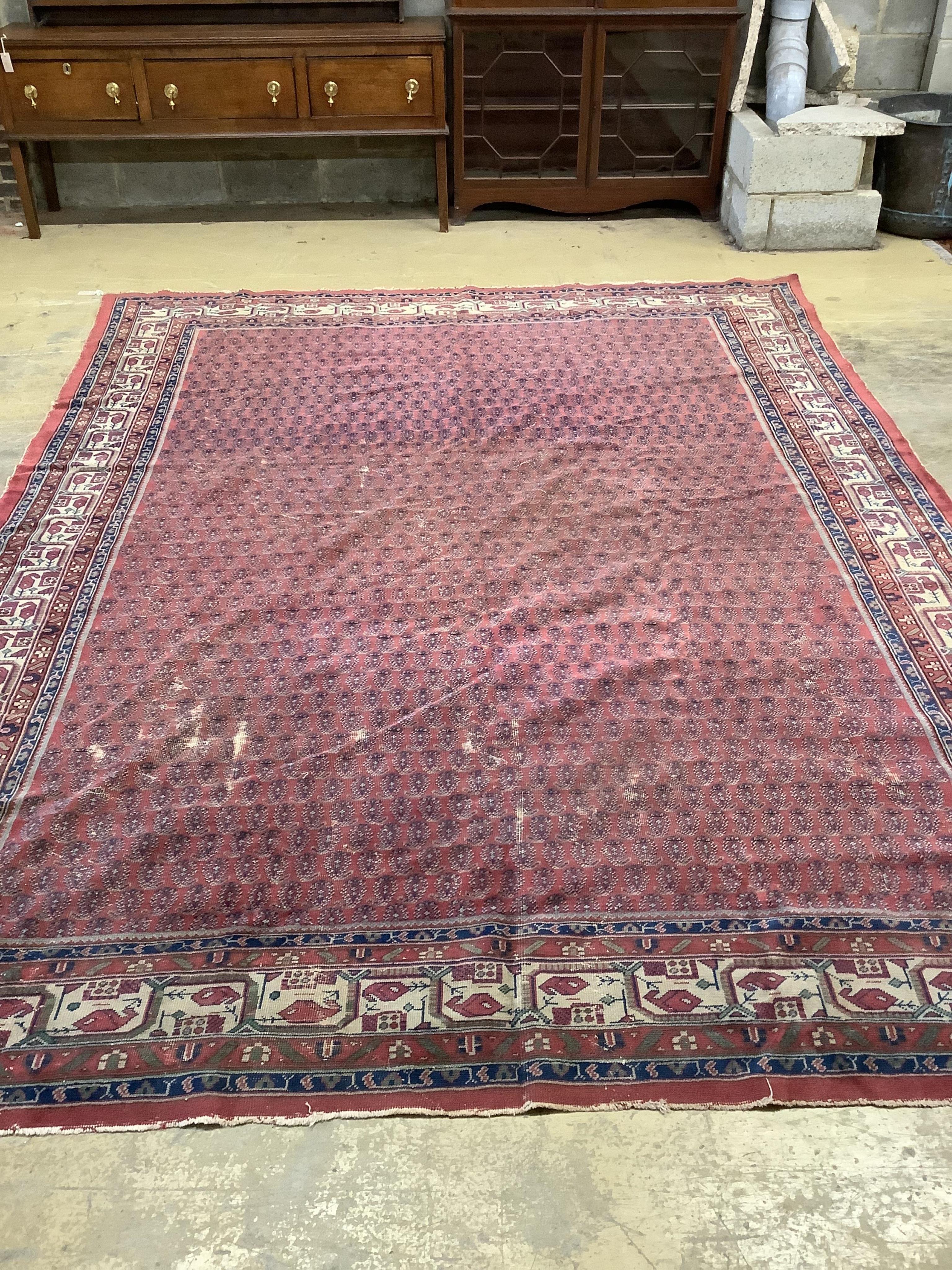 A Salouk red ground carpet, 350 x 265cm. Condition - poor to fair